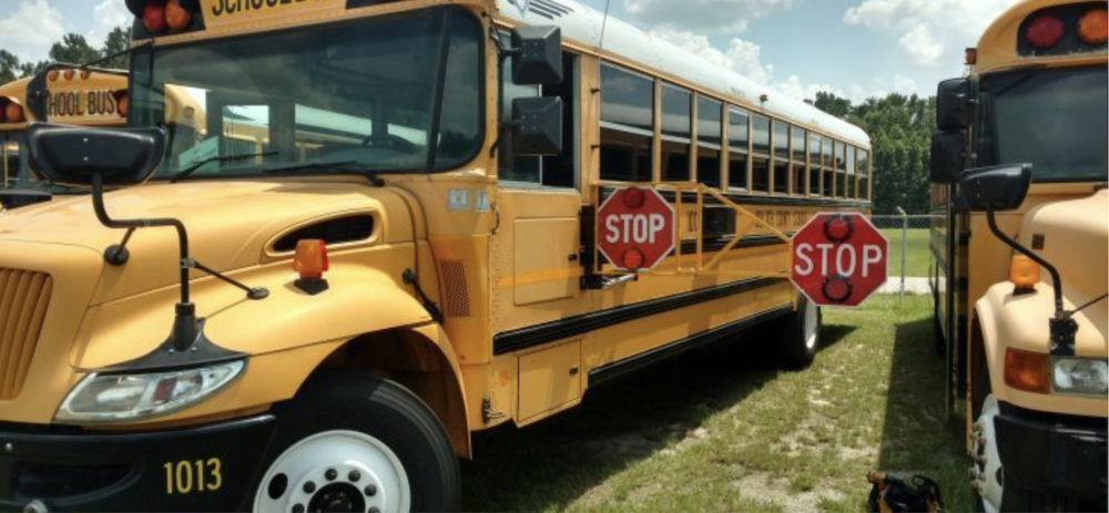 school buses parked with arm extended