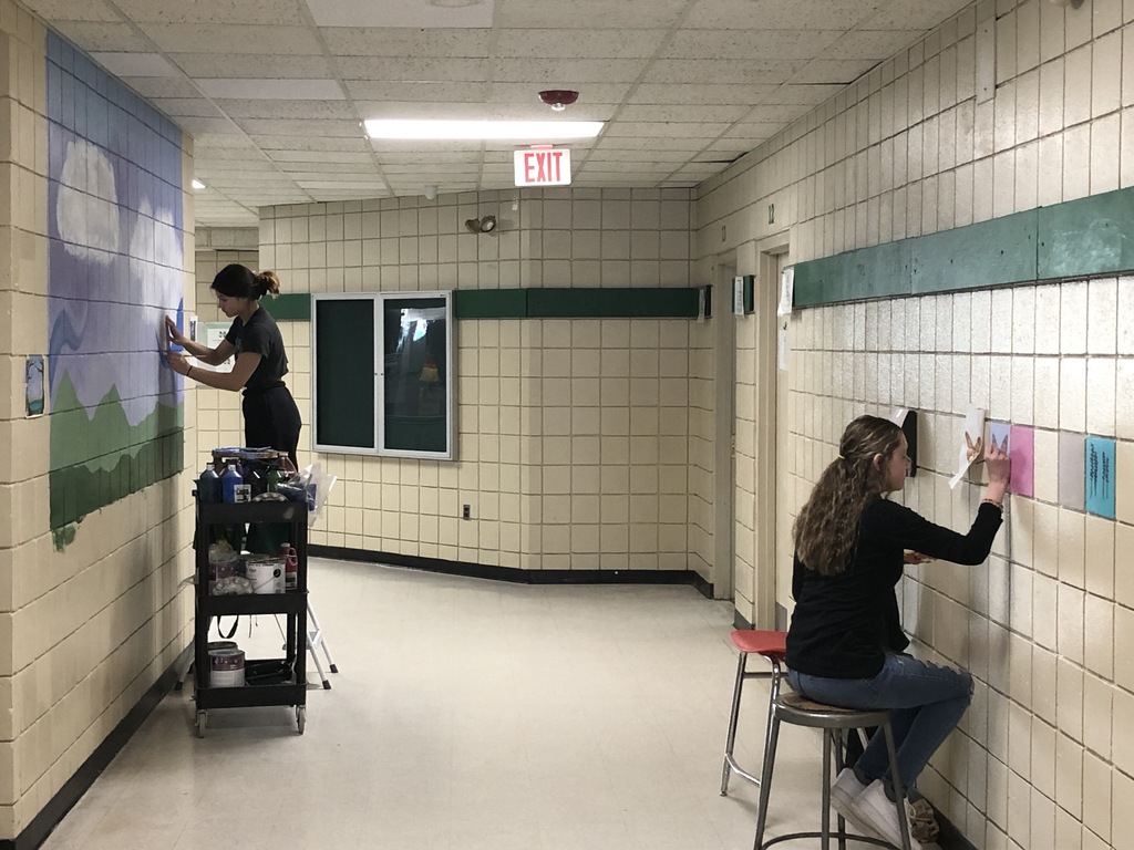 Photo of 2 students painting