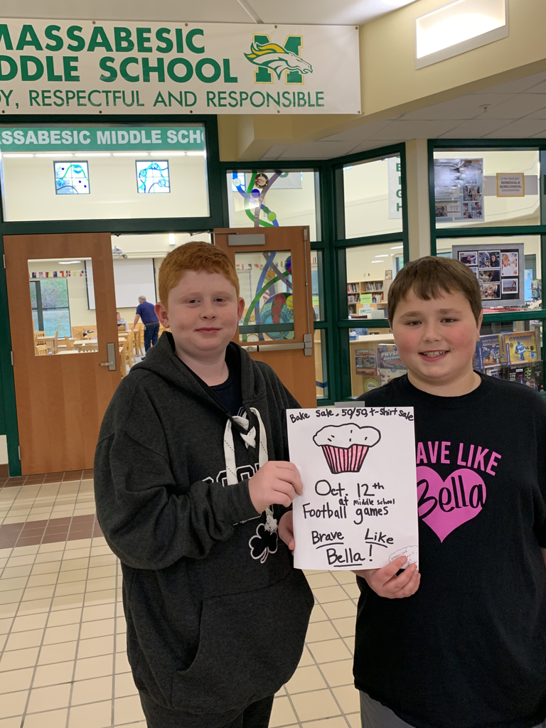 Jaxson Lamb and Zach Sotir, MMS 6th graders, hold a sign for Zach’s upcoming fundraiser at the middle school football games on October 12th.